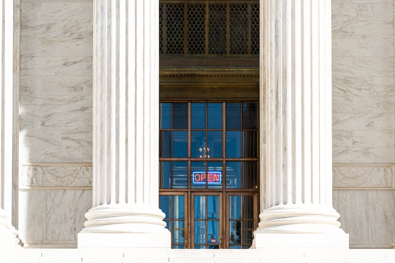 A federal building with an "OPEN" sign in the entrance.